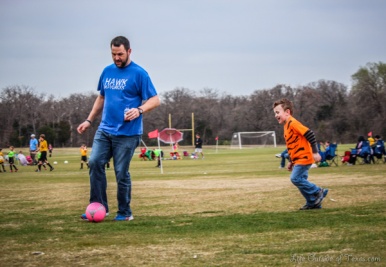 father and son playing soccer